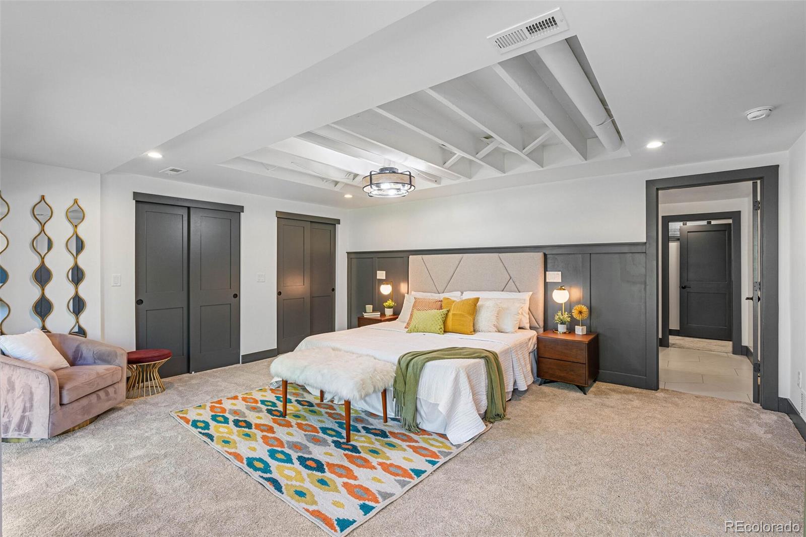 17 Rangeview Drive Wheat Ridge, CO 80215 - Photo 33 of 50 a bedroom with a bed and a chandelier