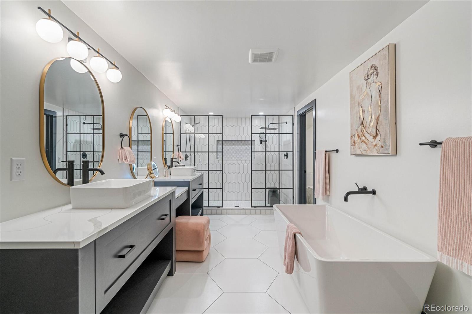 17 Rangeview Drive Wheat Ridge, CO 80215 - Photo 35 of 50 a spacious bathroom with a double vanity sink a mirror and a bathtub