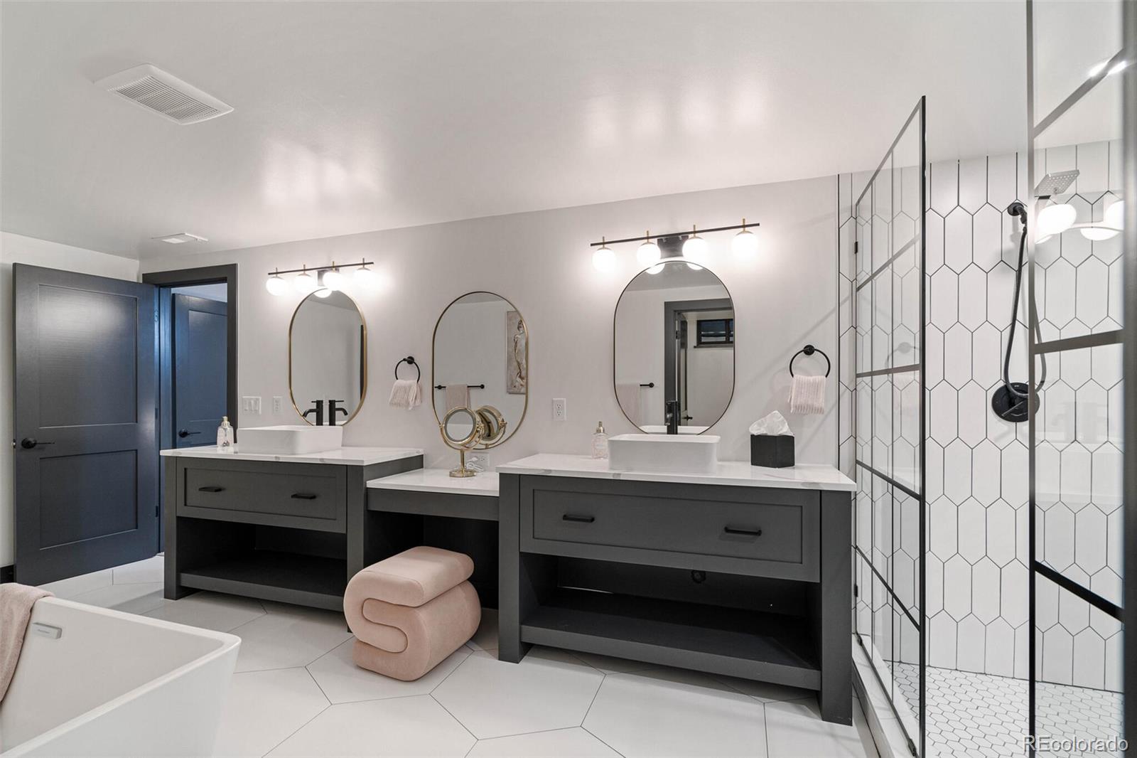 17 Rangeview Drive Wheat Ridge, CO 80215 - Photo 36 of 50 a spacious bathroom with a double vanity sink double and a mirror