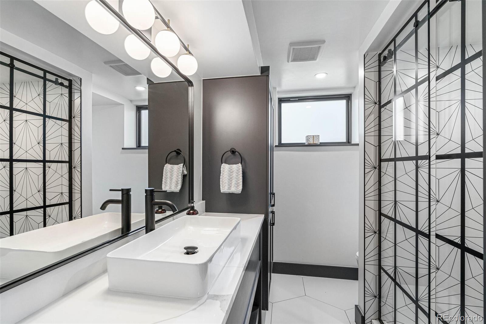 17 Rangeview Drive Wheat Ridge, CO 80215 - Photo 39 of 50 a bathroom with a sink mirror and vanity