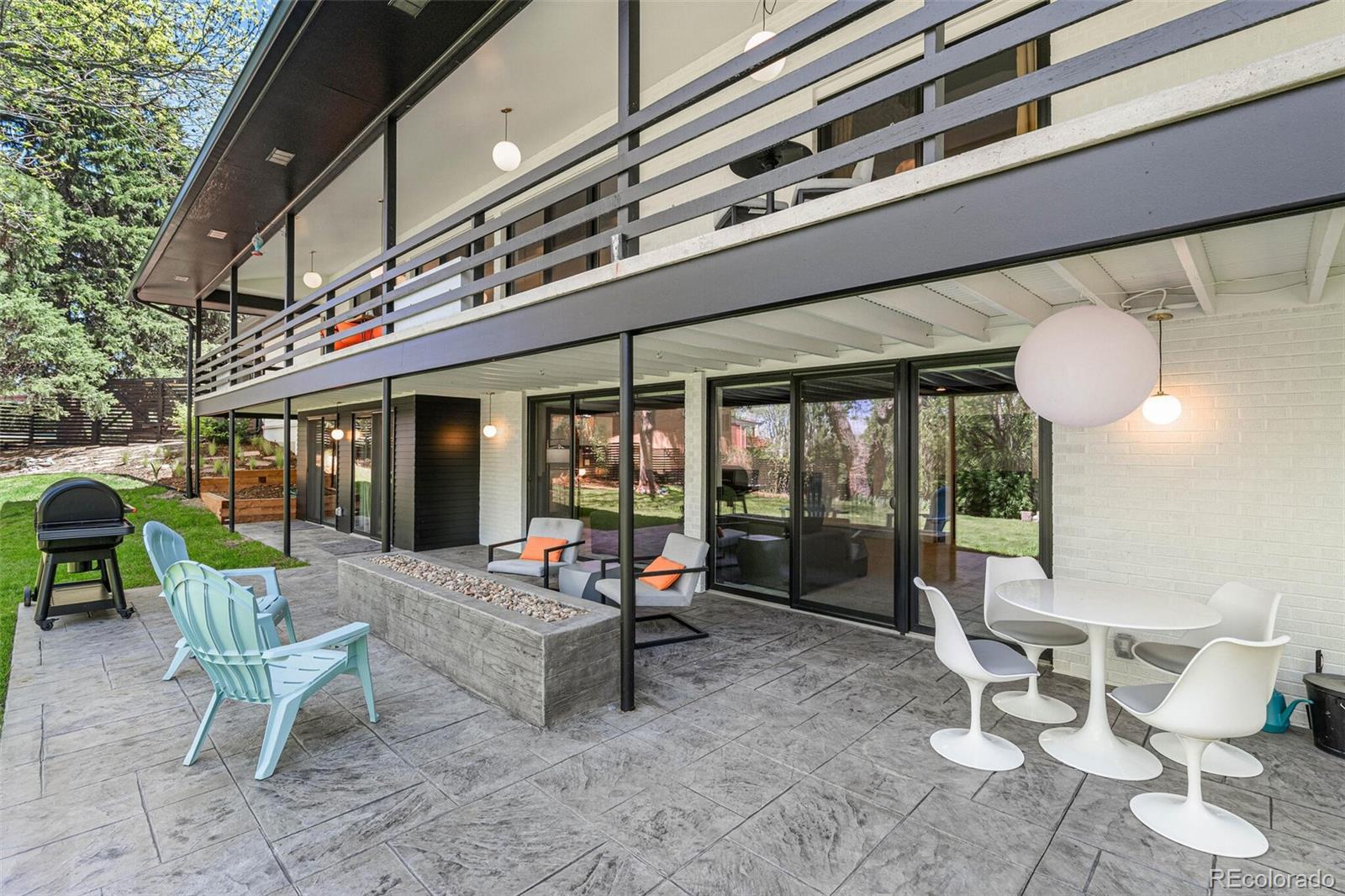 17 Rangeview Drive Wheat Ridge, CO 80215 - Photo 40 of 50 a view of a patio with a table and chairs and floor to ceiling window