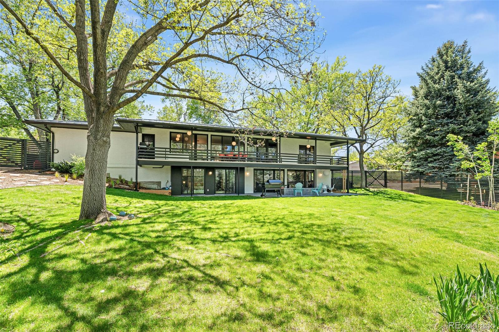 17 Rangeview Drive Wheat Ridge, CO 80215 - Photo 42 of 50 a view of a house with a big yard and large trees
