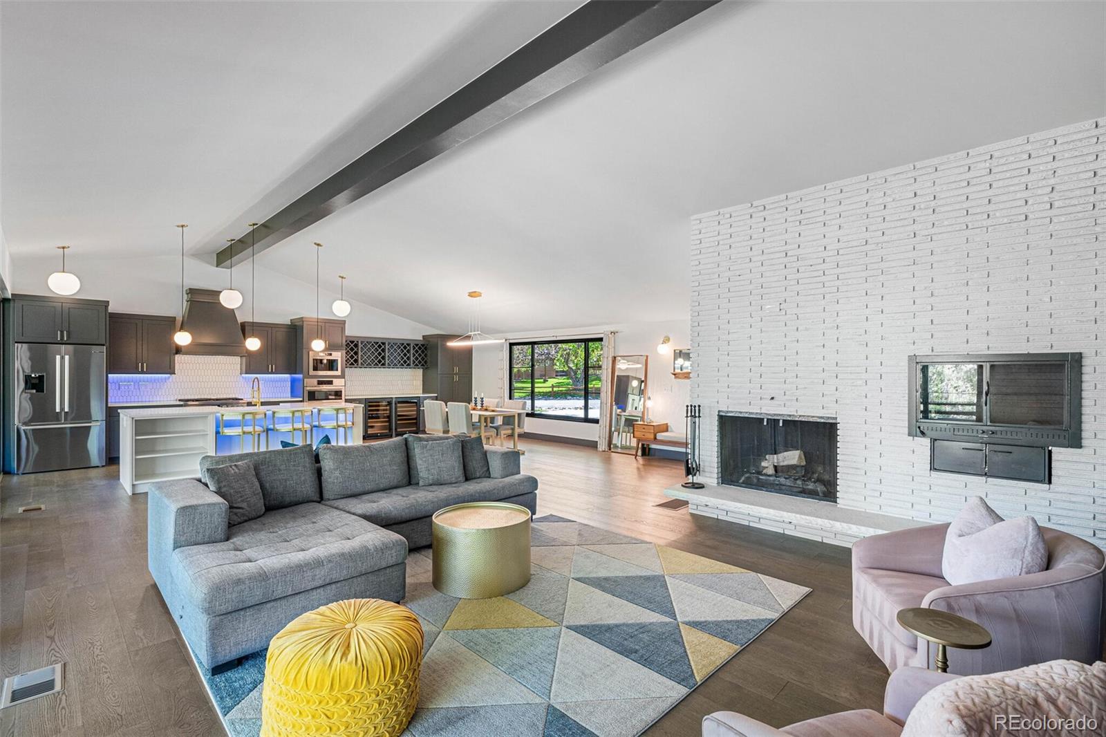 17 Rangeview Drive Wheat Ridge, CO 80215 - Photo 5 of 50 a living room with furniture a fireplace and a flat screen tv