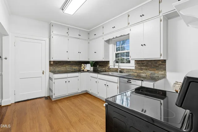 a kitchen with granite countertop a stove and a refrigerator