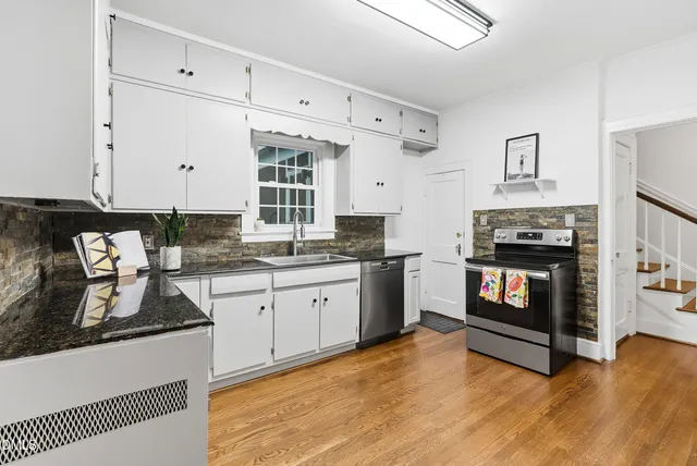 a kitchen with stainless steel appliances a refrigerator and a stove top oven