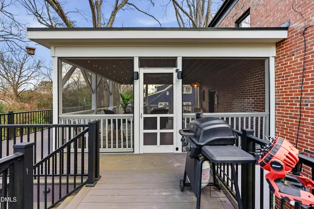 a view of house with a large window and wooden fence