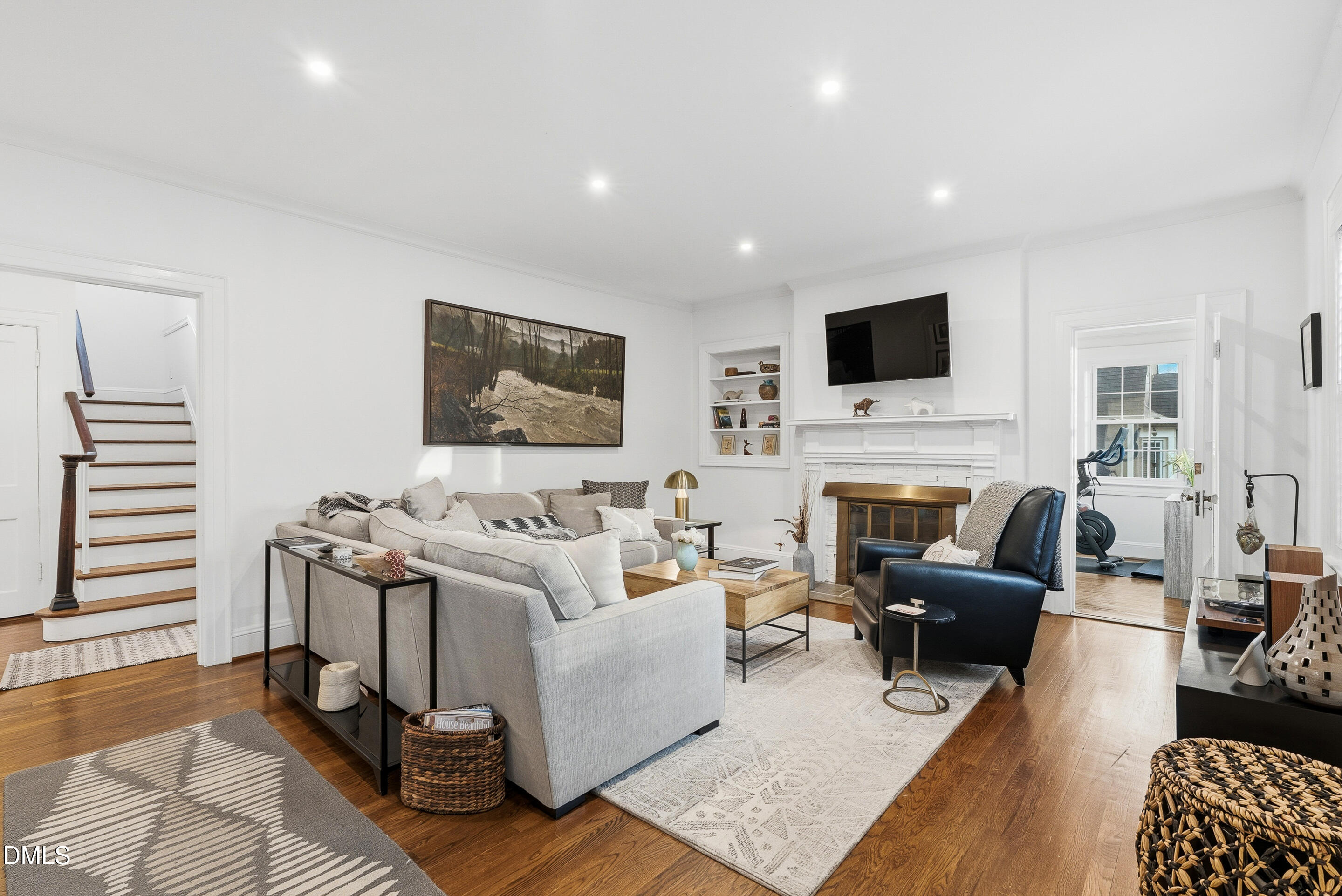 1110 North Gregson Street Durham, NC 27701 - Photo 6 of 38 a living room with furniture a flat screen tv and a fireplace