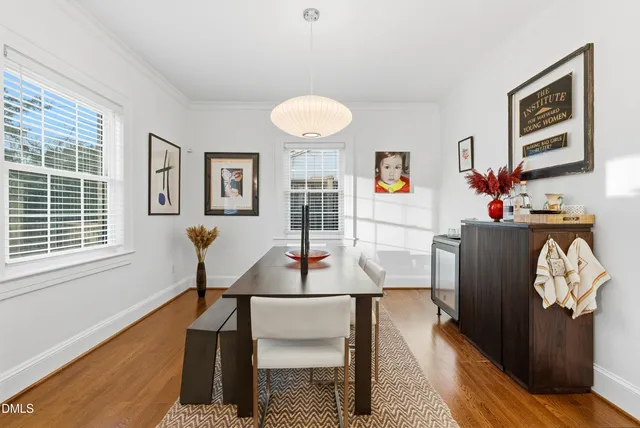 a dining room with furniture and wooden floor