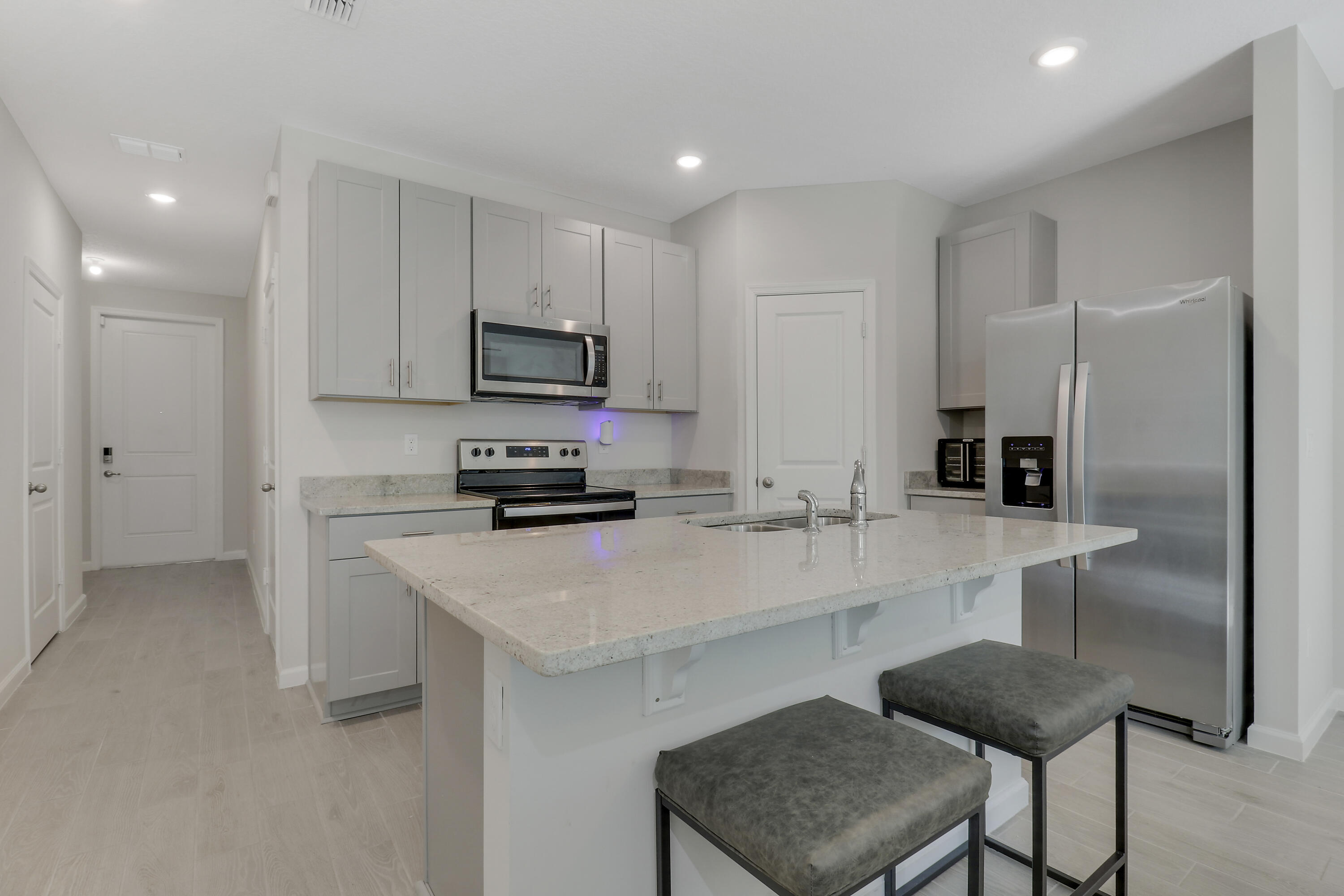 3903 Southeast Mentmore Lane Stuart, FL 34997 - Photo 15 of 35 a kitchen with a sink cabinets and refrigerator