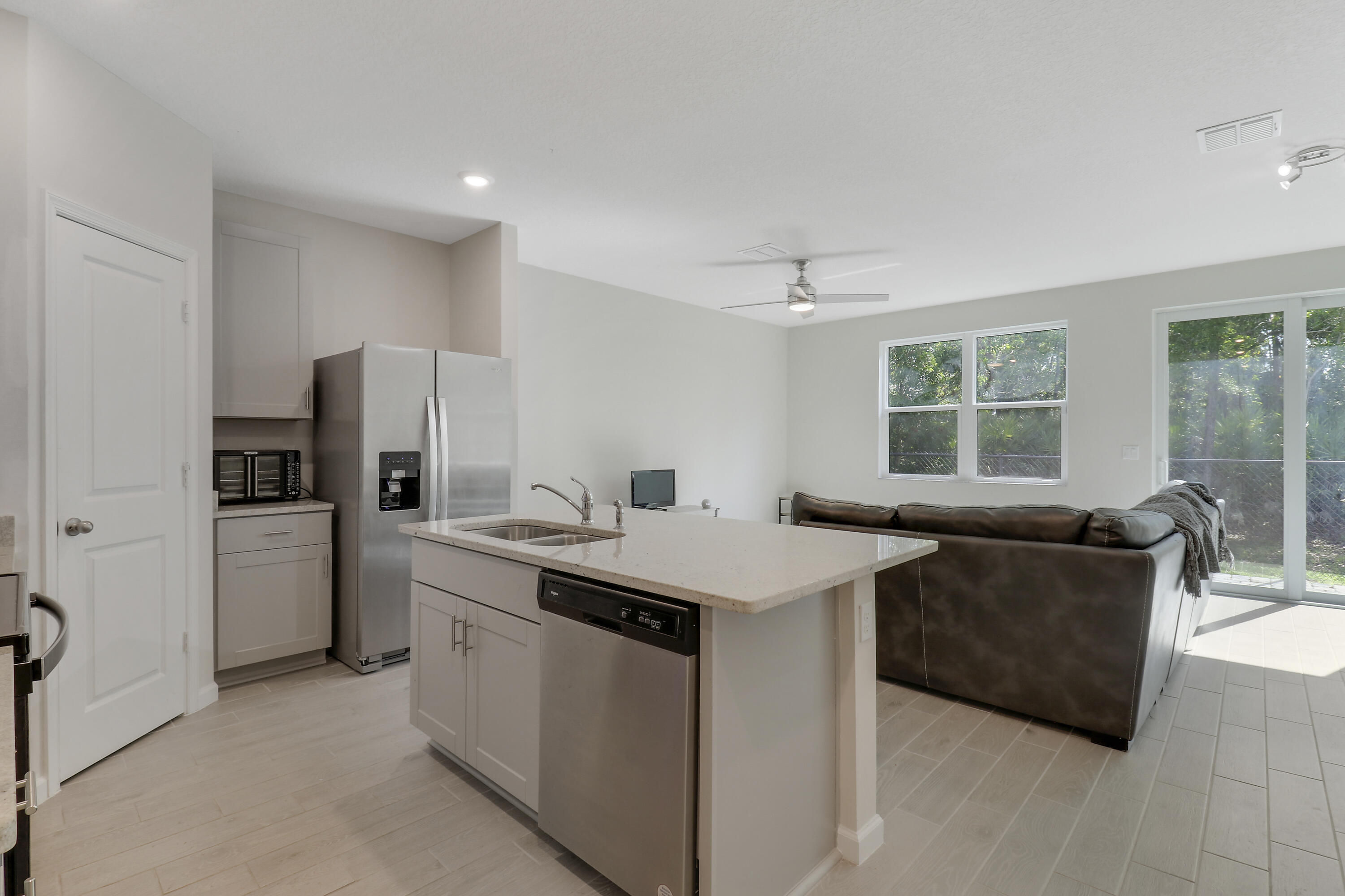 3903 Southeast Mentmore Lane Stuart, FL 34997 - Photo 22 of 35 a view of kitchen with stainless steel appliances kitchen island a sink stove and refrigerator