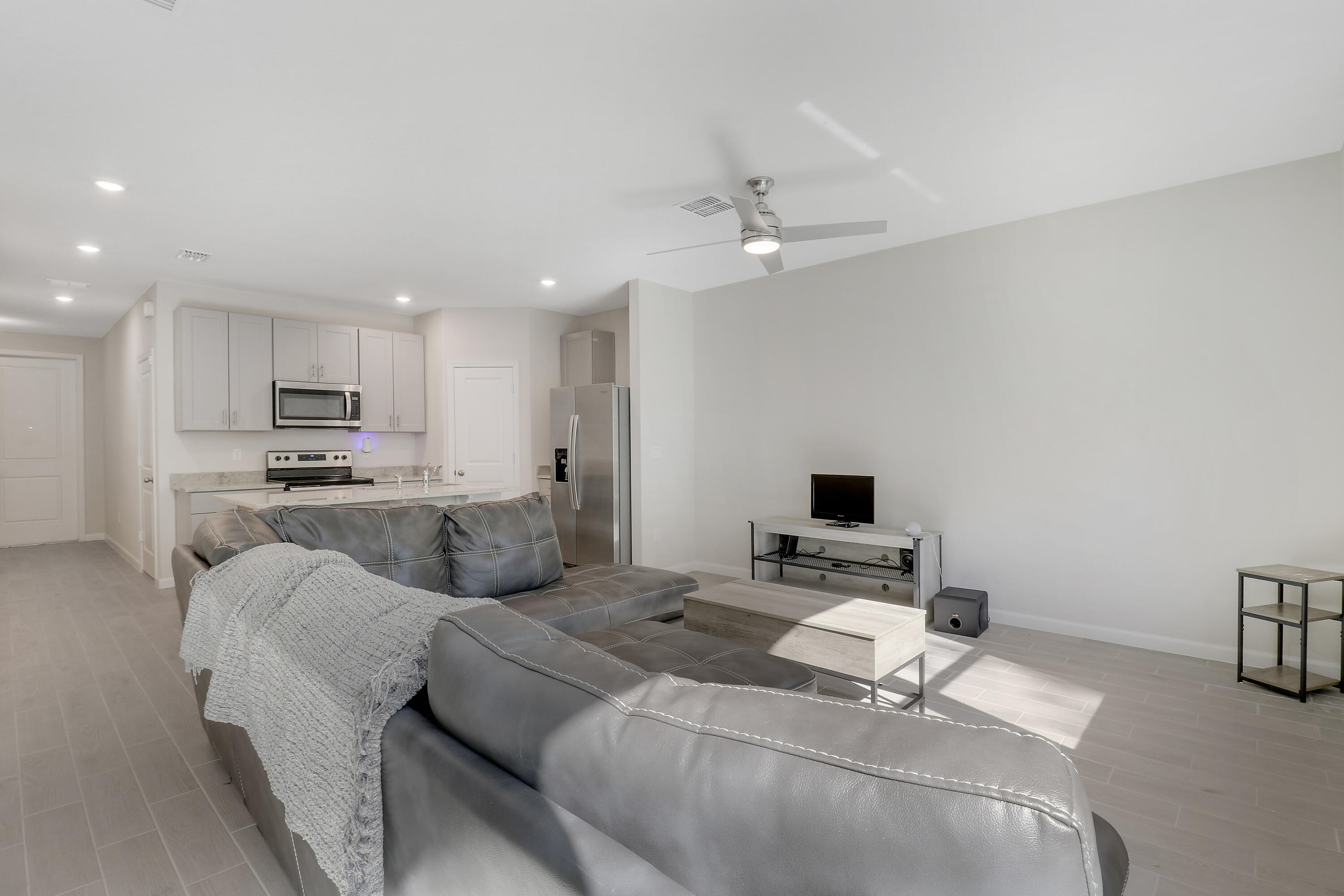 3903 Southeast Mentmore Lane Stuart, FL 34997 - Photo 23 of 35 a living room with furniture and a flat screen tv