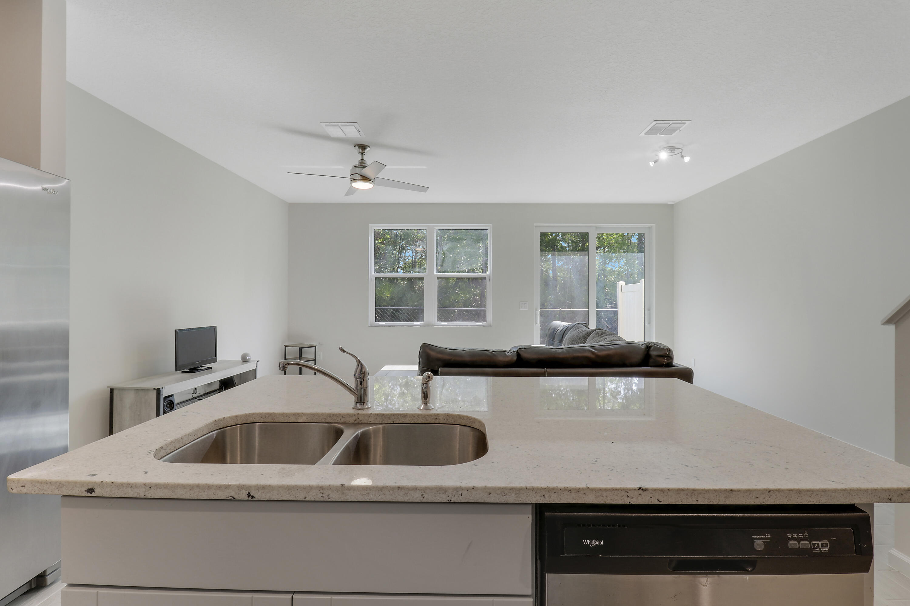 3903 Southeast Mentmore Lane Stuart, FL 34997 - Photo 26 of 35 a kitchen with stainless steel appliances a sink a stove and a window