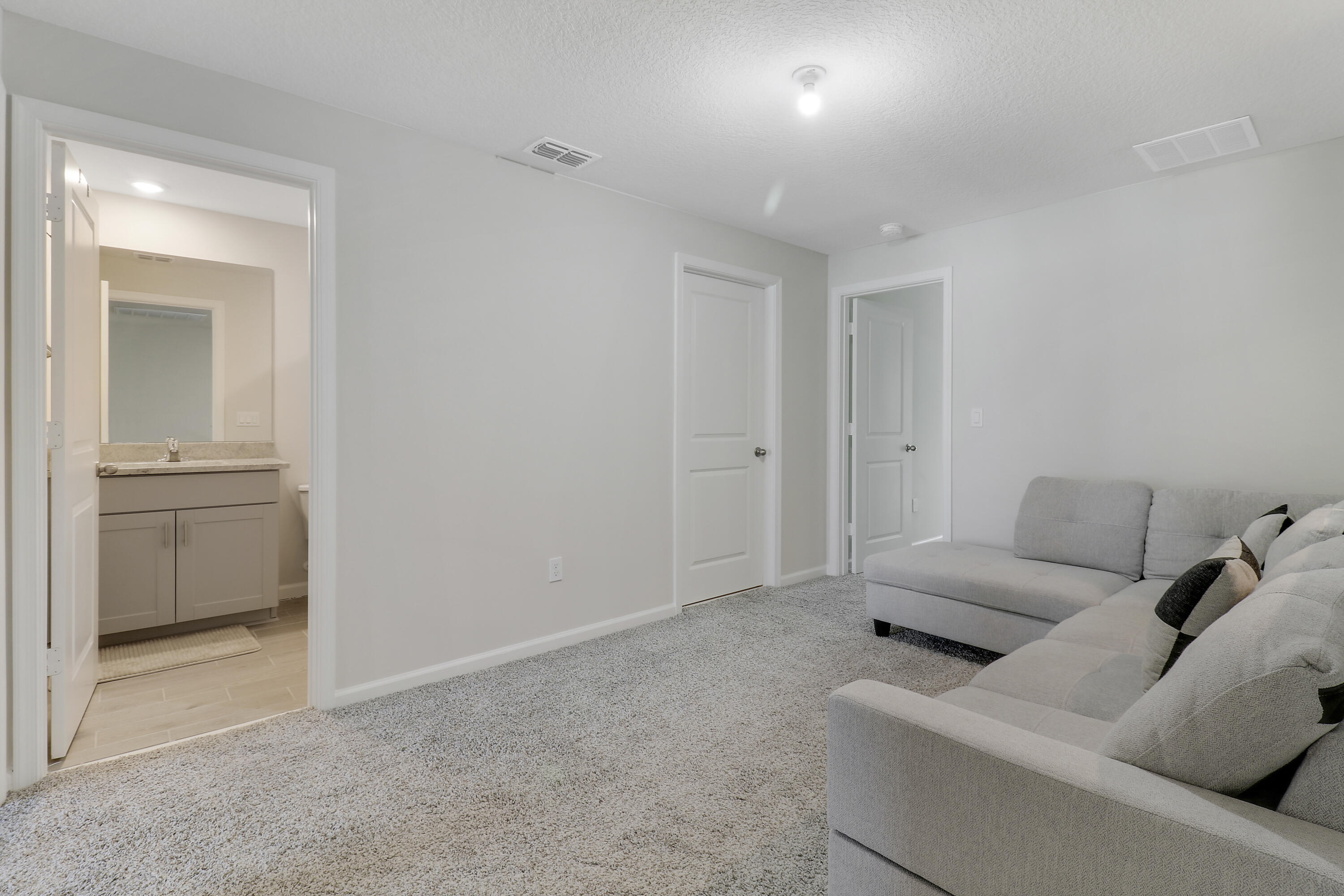 3903 Southeast Mentmore Lane Stuart, FL 34997 - Photo 31 of 35 a living room with furniture and a walk in closet