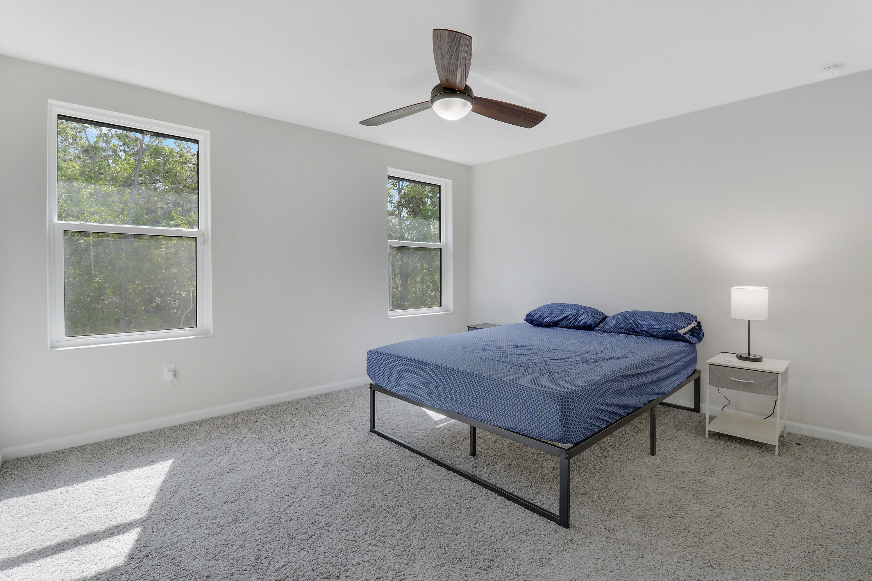 3903 Southeast Mentmore Lane Stuart, FL 34997 - Photo 34 of 35 a bedroom with a bed and a window