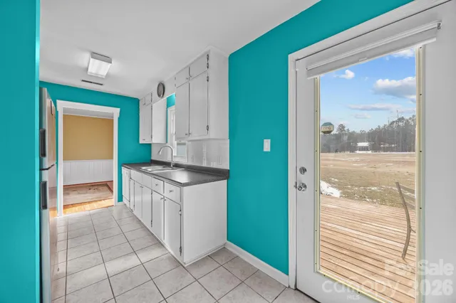 a kitchen with granite countertop a sink and a stove next to a window