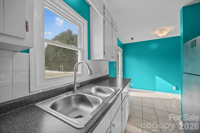 a kitchen with a sink and a large window