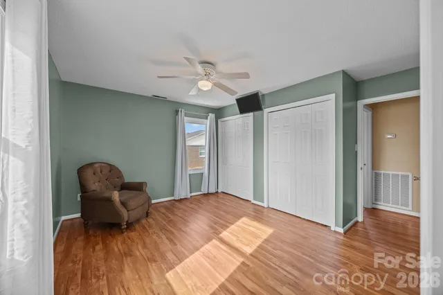 a bedroom with a bed and a chair