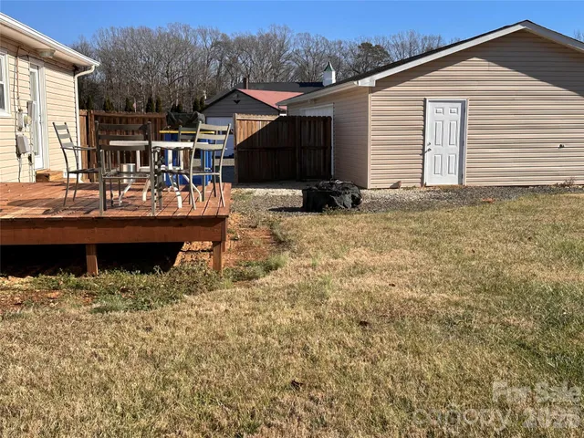 a view of house with backyard and seating area