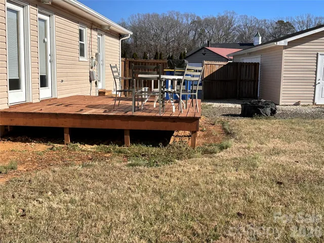 a view of house with backyard and seating area