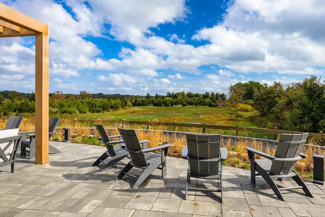 a view of a building with a table and chairs in patio