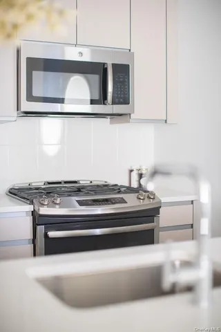 a living room with a stove and a cabinet