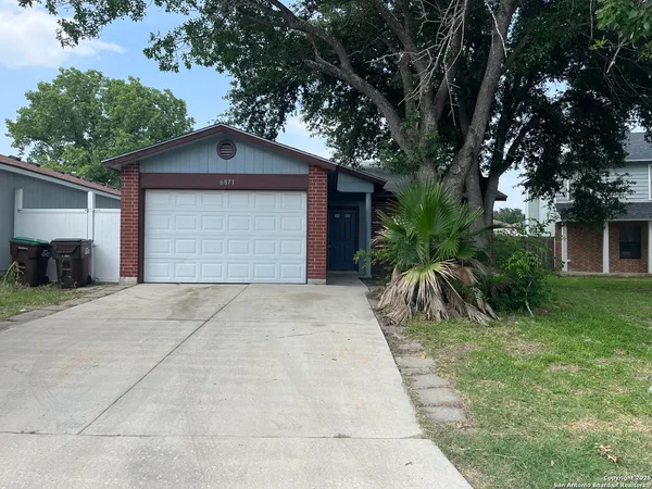 a front view of house with yard and trees