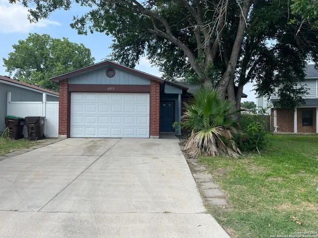 a front view of house with yard and trees