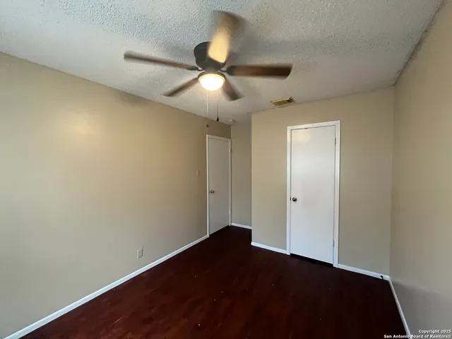 a view of an empty room and wooden floor