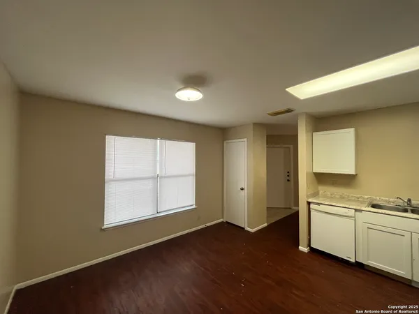 a view of a kitchen with wooden floor and a sink
