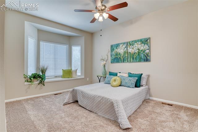 2002 Legacy Ridge View, Unit 101 Colorado Springs, CO 80910 - Photo 3 of 11 Bedroom featuring ceiling fan and carpet flooring
