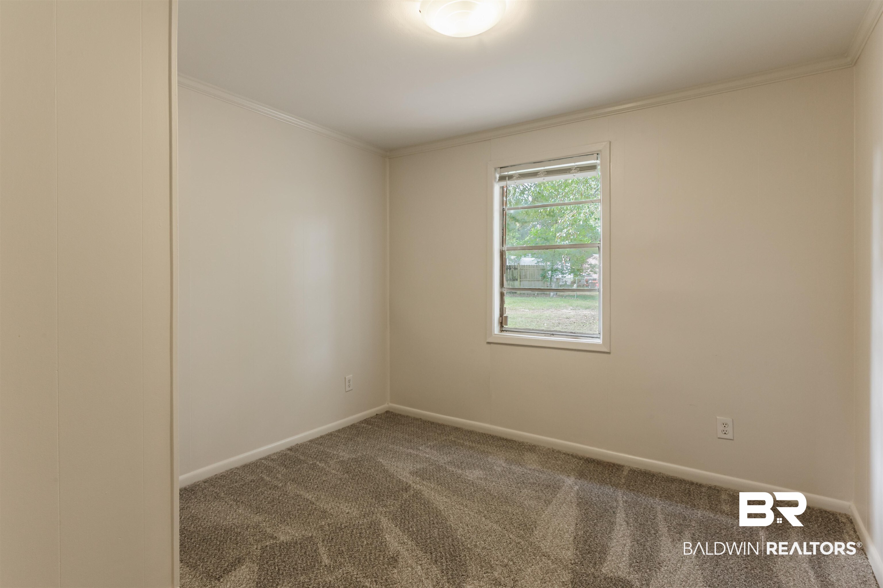 3970 Oak Ridge Avenue Mobile, AL 36619 - Photo 10 of 28 Carpeted empty room featuring crown molding