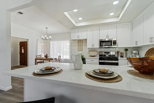 a kitchen with a sink a stove and cabinets