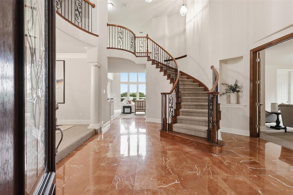 2841 Meadow Ridge Drive Prosper, TX 75078 - Photo 3 of 40 a view of entryway and hall with wooden floor