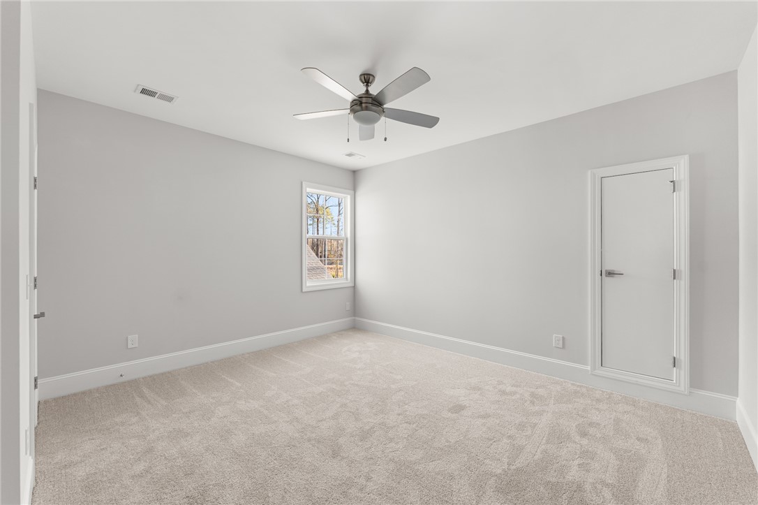 141 Rickys Path Easley, SC 29642 - Photo 36 of 40 This spacious bedroom offers comfortable carpeting, ample natural light, and a refreshing ceiling fan.