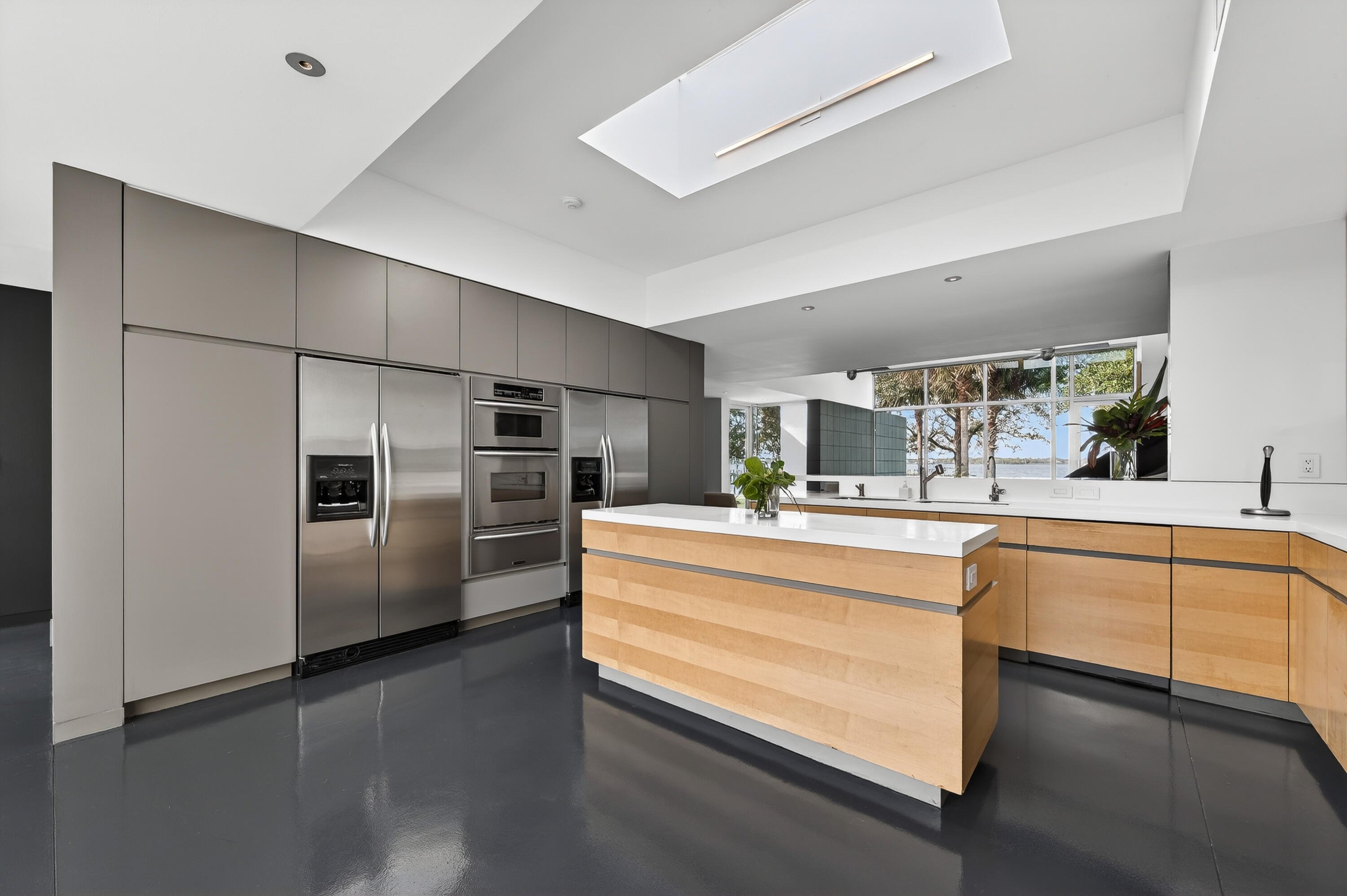 1924 Northwest Shore Terrace Stuart, FL 34994 - Photo 35 of 79 a kitchen with stainless steel appliances granite countertop a refrigerator and a sink