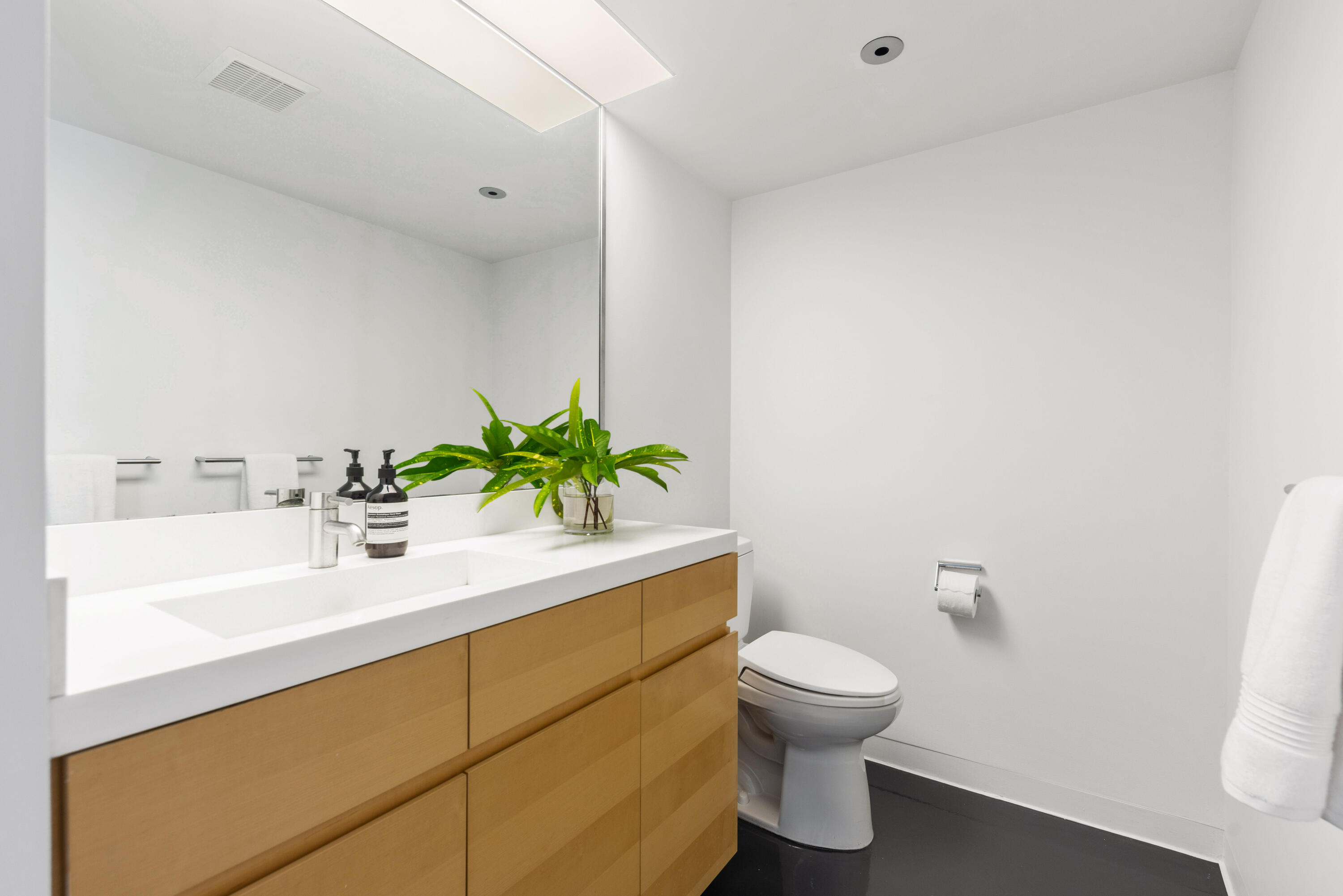1924 Northwest Shore Terrace Stuart, FL 34994 - Photo 55 of 79 a bathroom with a sink toilet and a mirror