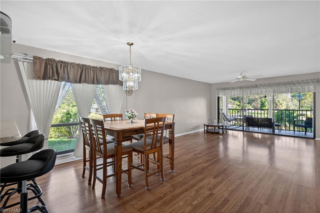 1223 Commonwealth Circle, Unit F201 Naples, FL 34116 - Photo 11 of 25 a view of a dining room with furniture window and wooden floor