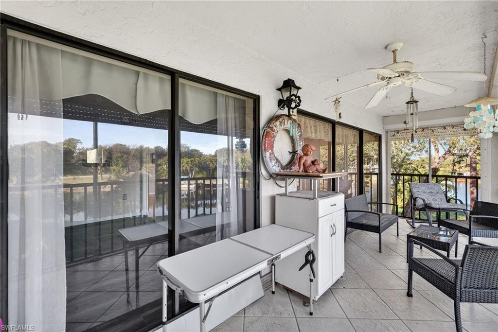 1223 Commonwealth Circle, Unit F201 Naples, FL 34116 - Photo 14 of 25 a very nice looking dining room with a large window with outer view