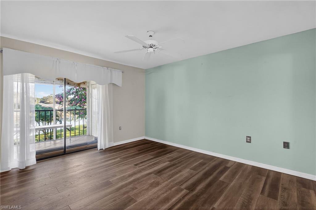1223 Commonwealth Circle, Unit F201 Naples, FL 34116 - Photo 15 of 25 a view of an empty room with wooden floor and a window