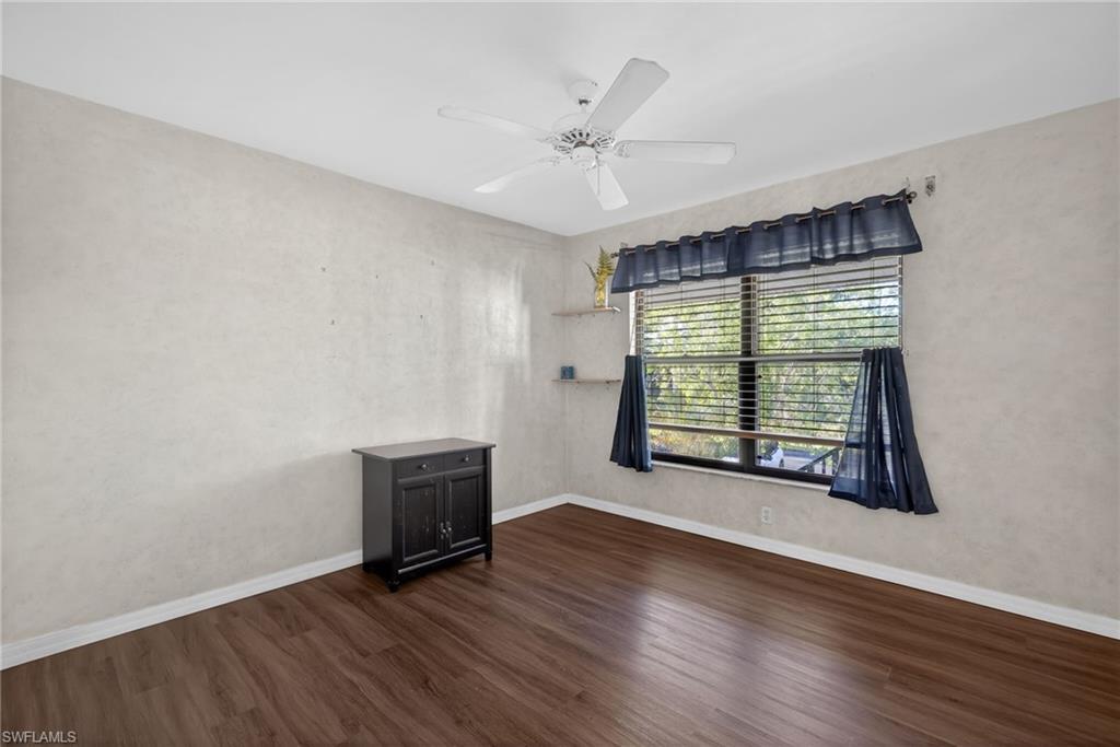 1223 Commonwealth Circle, Unit F201 Naples, FL 34116 - Photo 19 of 25 an empty room with wooden floor and windows