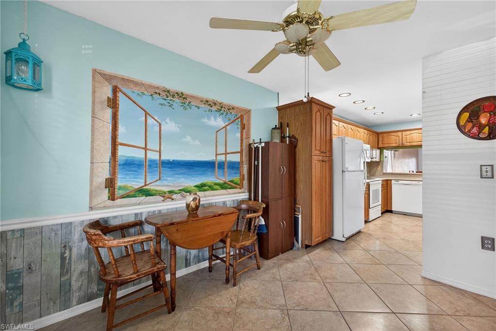 1223 Commonwealth Circle, Unit F201 Naples, FL 34116 - Photo 3 of 25 a room with furniture a chandelier and a window