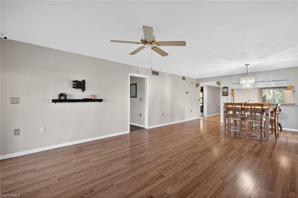 1223 Commonwealth Circle, Unit F201 Naples, FL 34116 - Photo 8 of 25 wooden floor in an empty room with a window