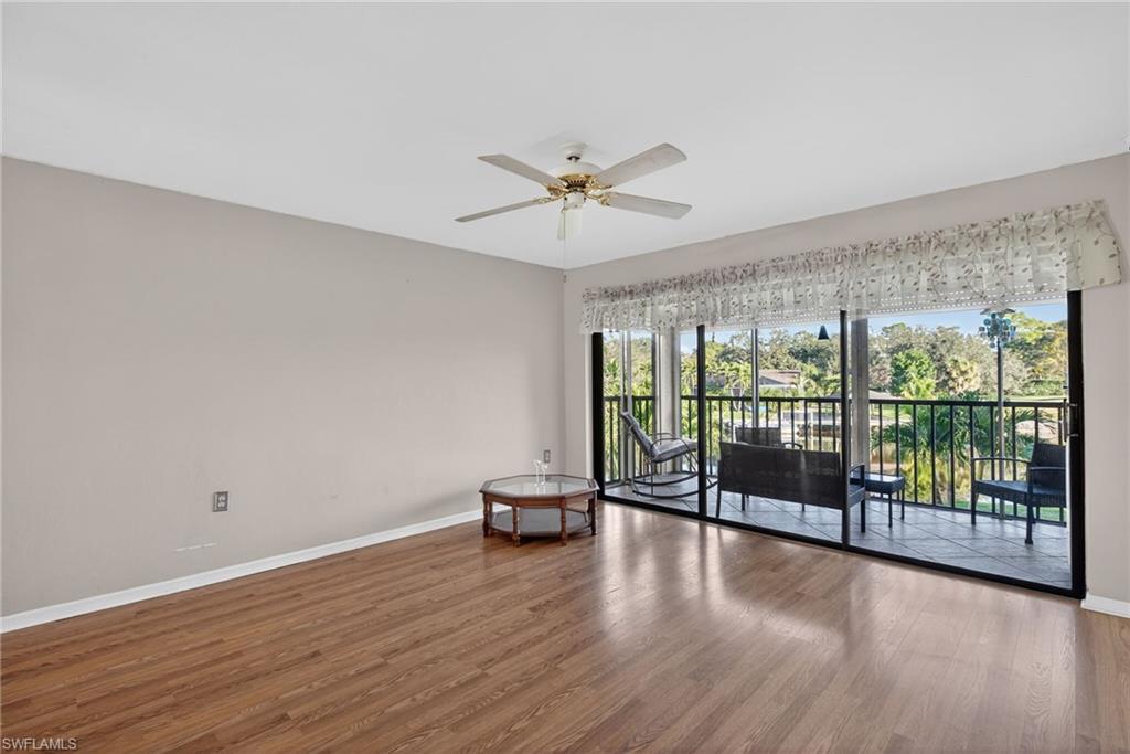 1223 Commonwealth Circle, Unit F201 Naples, FL 34116 - Photo 10 of 25 wooden floor in an empty room with a window