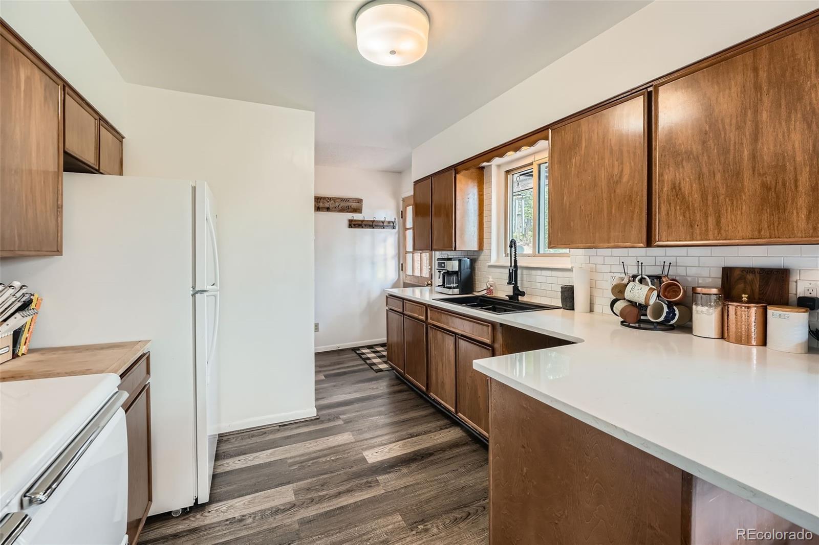 28669 Mountain View Road Conifer, CO 80433 - Photo 2 of 40 a kitchen with a refrigerator stove and sink