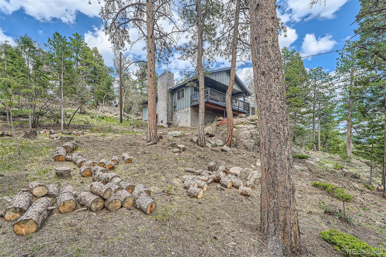 28669 Mountain View Road Conifer, CO 80433 - Photo 24 of 40 front view of a house with a yard