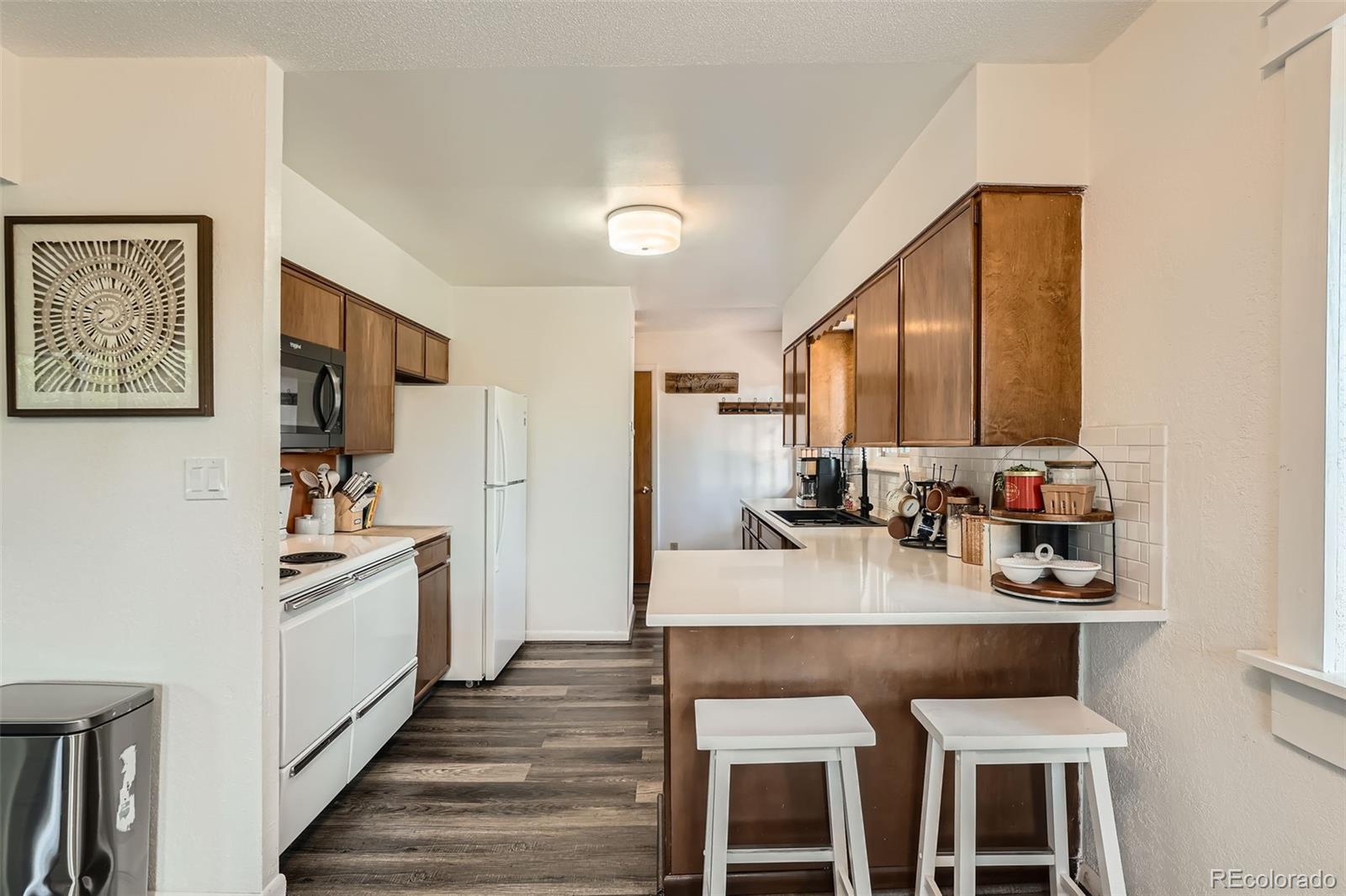 28669 Mountain View Road Conifer, CO 80433 - Photo 3 of 40 a kitchen with stainless steel appliances a stove a sink and a refrigerator