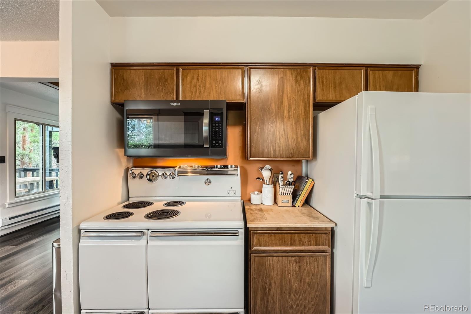 28669 Mountain View Road Conifer, CO 80433 - Photo 5 of 40 a white refrigerator freezer sitting inside of a kitchen