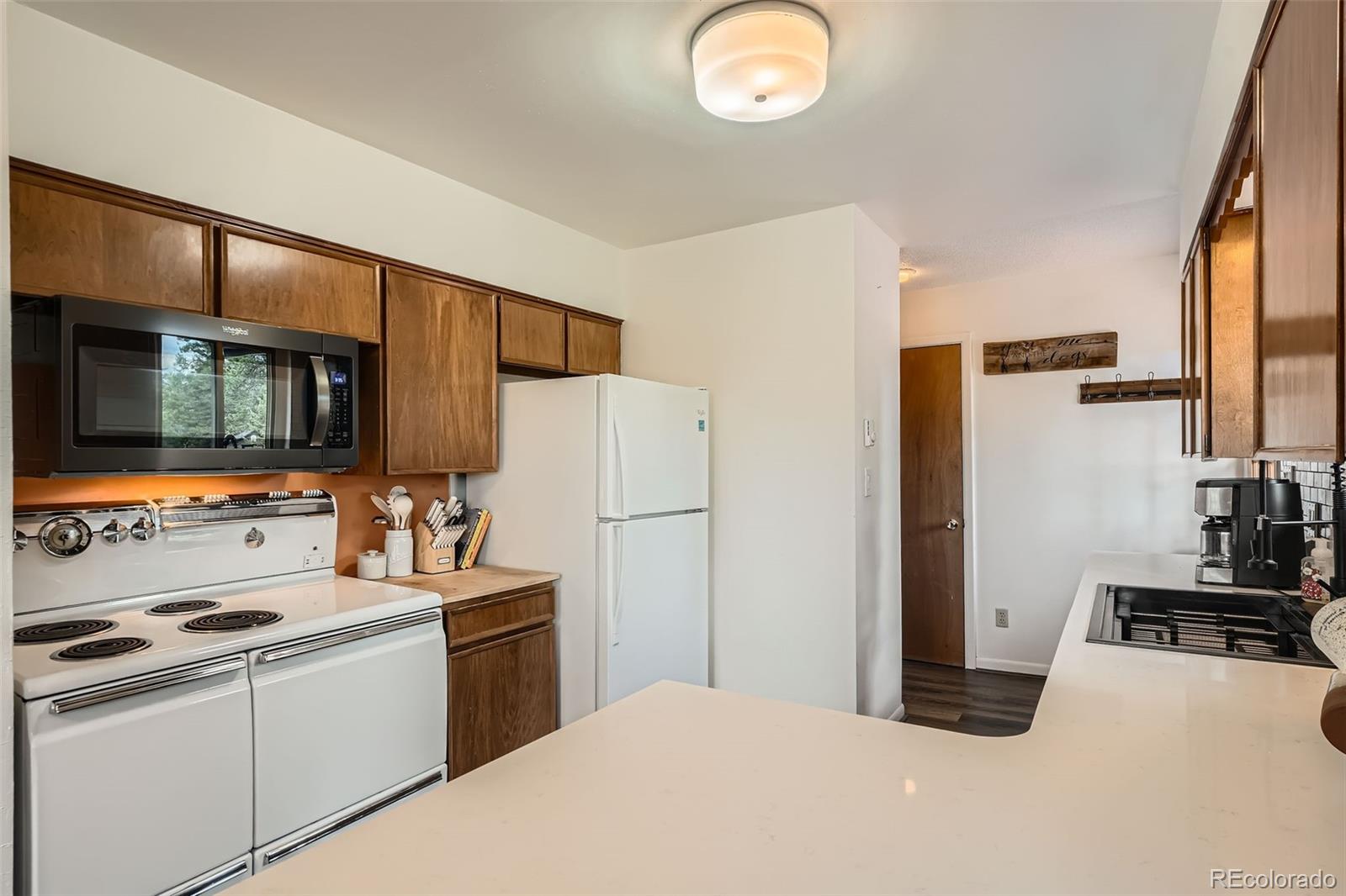 28669 Mountain View Road Conifer, CO 80433 - Photo 6 of 40 a kitchen with stainless steel appliances a refrigerator stove and sink
