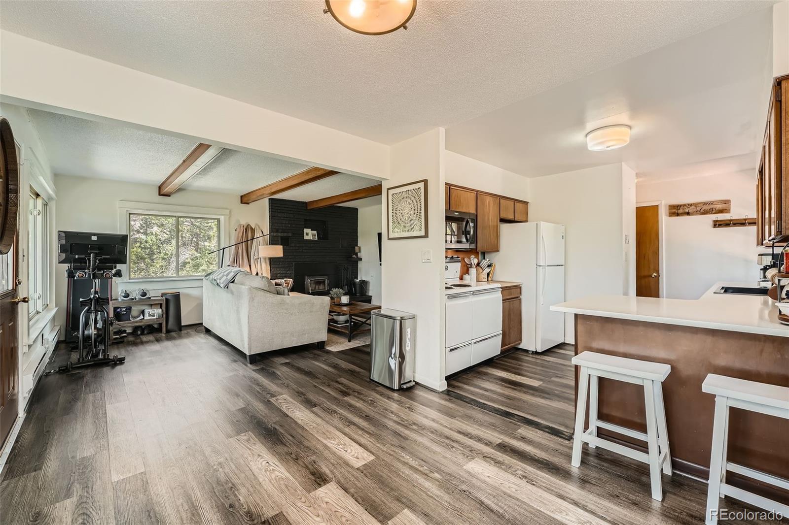 28669 Mountain View Road Conifer, CO 80433 - Photo 9 of 40 a living room with furniture and a wooden floor