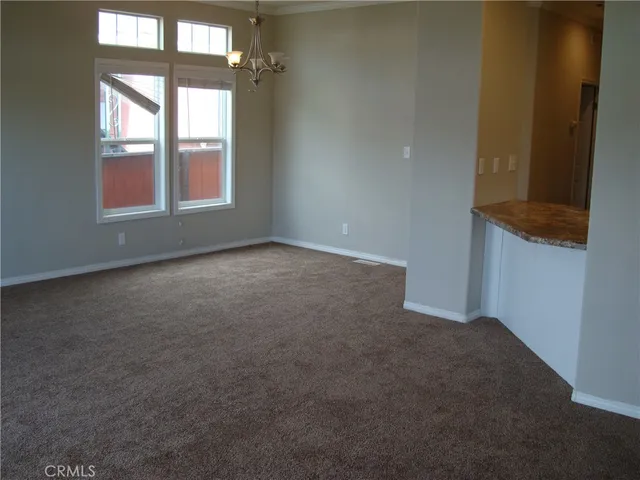 a kitchen with granite countertop a sink and cabinets